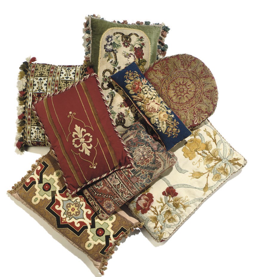 A LARGE GROUP OF CUSHIONS