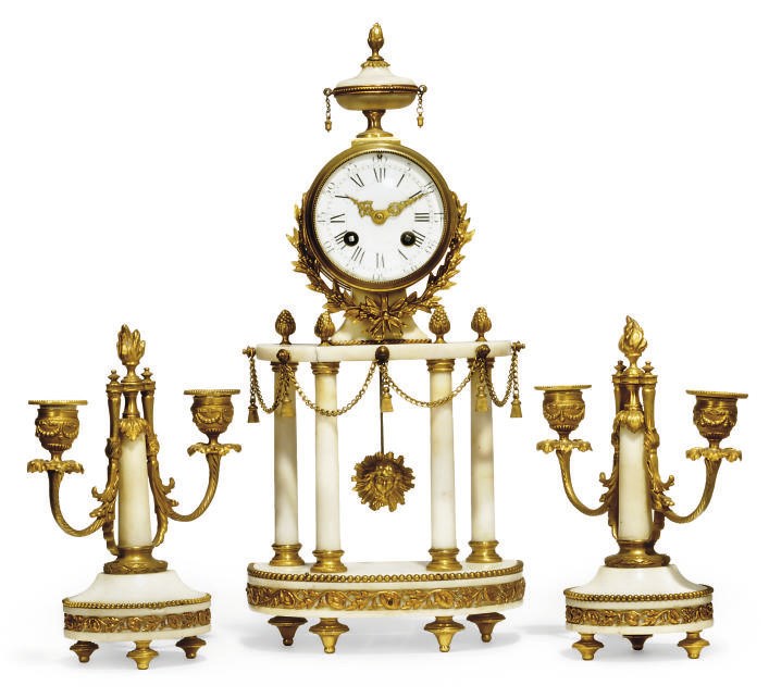 A French gilt-brass mounted marble striking eight day mantel clock with matching pair of twin-light candelabra