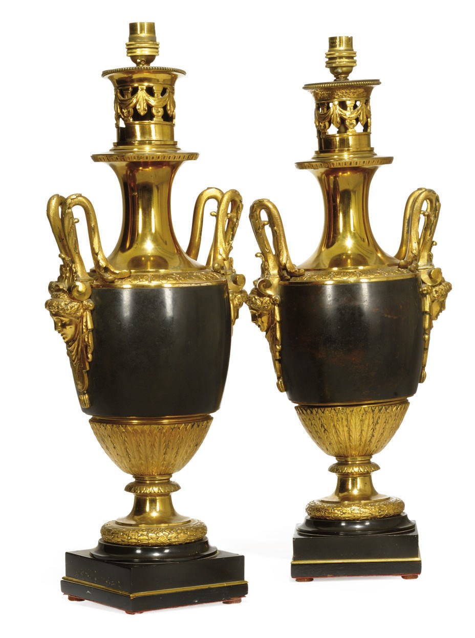 A PAIR OF BRONZE AND PARCEL GILT TABLE OIL LAMPS