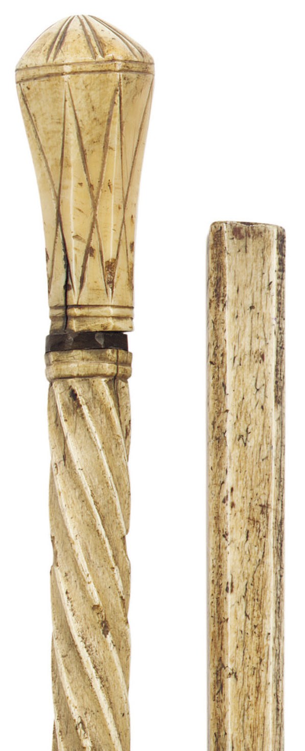 A CARVED WHALE-BONE WALKING STICK