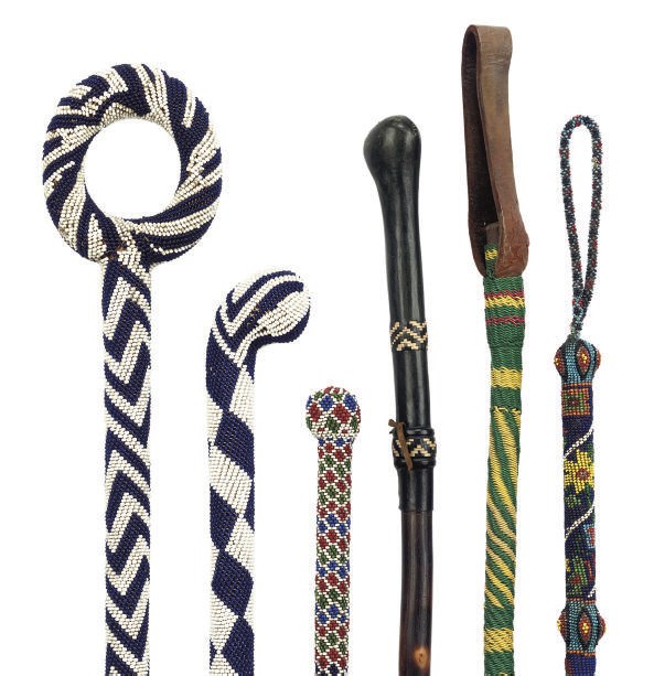 A COLLECTION OF FOUR SOUTH AFRICAN GLASS-BEAD DECORATED WALKING STICKS OR CROPS