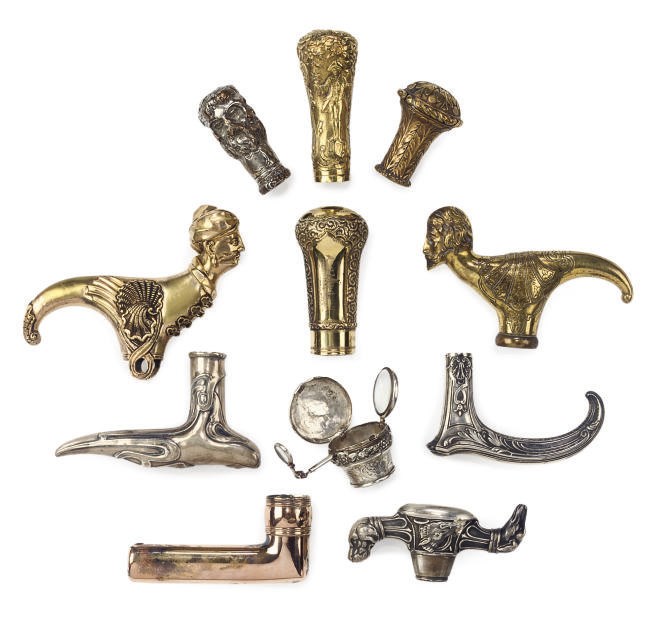 A COLLECTION OF ELEVEN SILVER AND BASE METAL WALKING CANE HANDLES