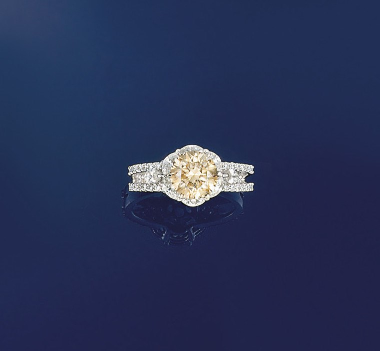 A coloured diamond single stone ring