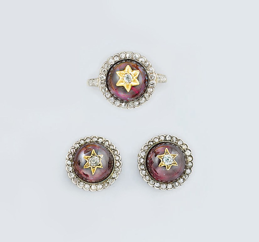 A garnet and diamond ring and matching earstuds