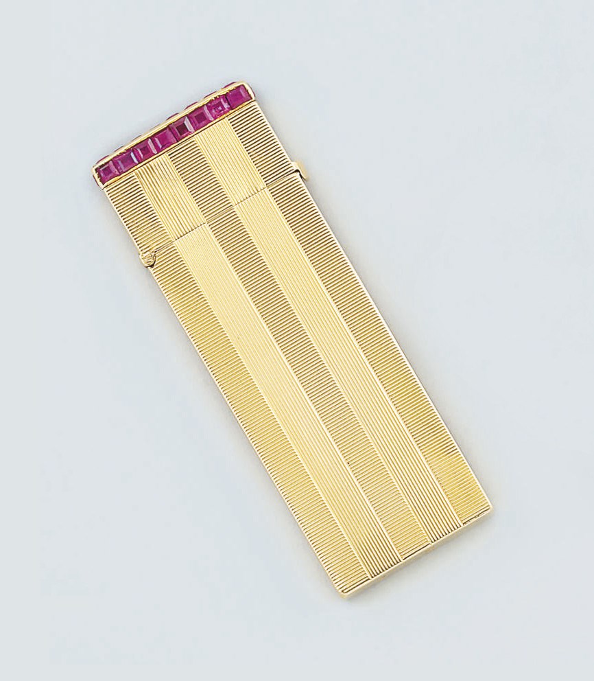 A gold and ruby set petrol cigarette lighter by Van Cleef & Arpels