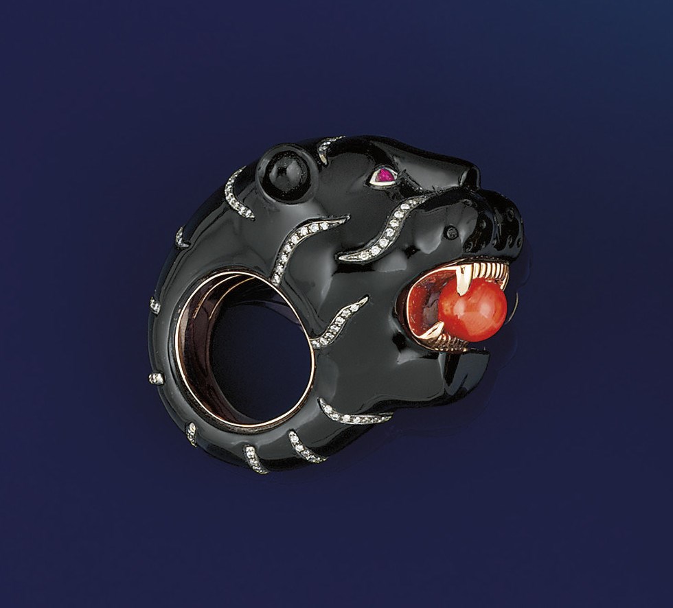 A large onyx and gem ring