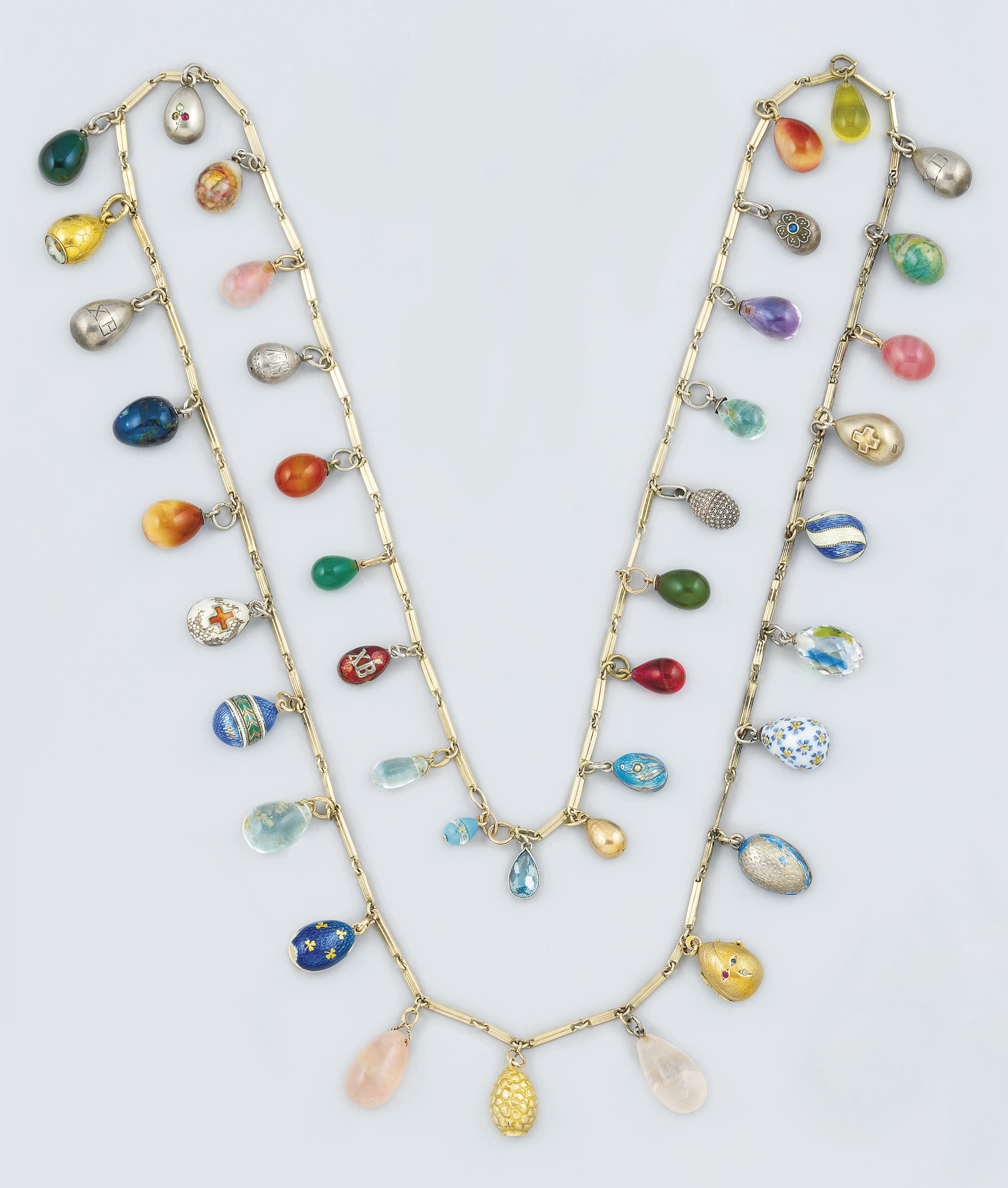 A gilt necklace suspending forty-one Russian miniature egg-pendants