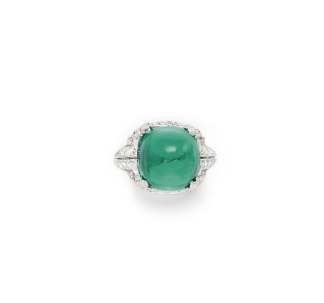 A DIAMOND AND SIMULATED EMERALD RING
