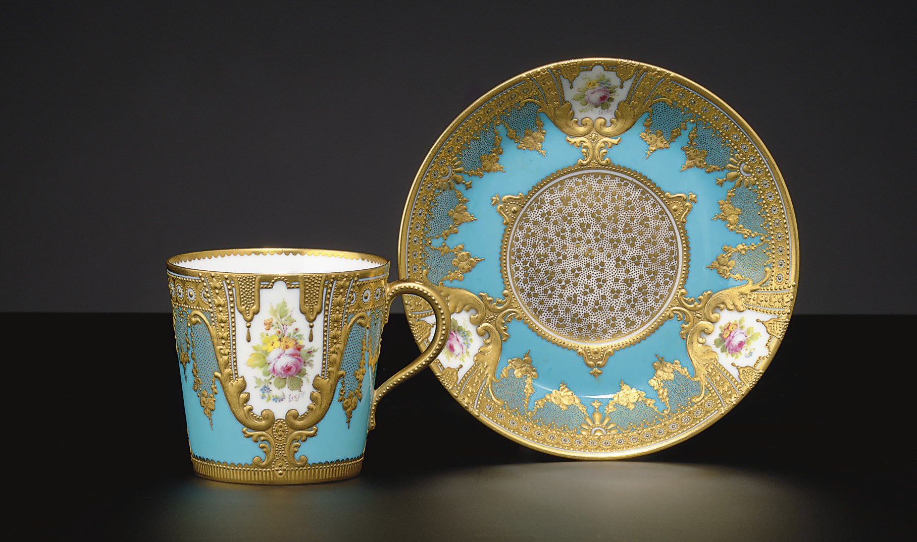 A ROYAL CROWN DERBY 'JEWELED' TURQUOISE-GROUND CUP AND SAUCER