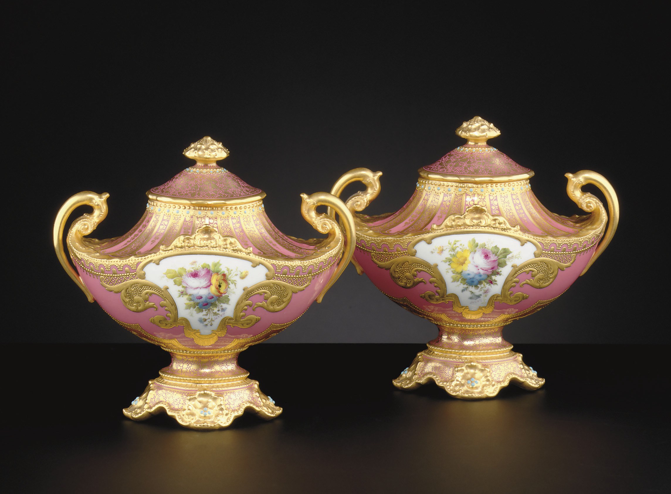 A PAIR OF ROYAL CROWN DERBY 'JEWELED' PINK AND GOLD GROUND VASES AND COVERS