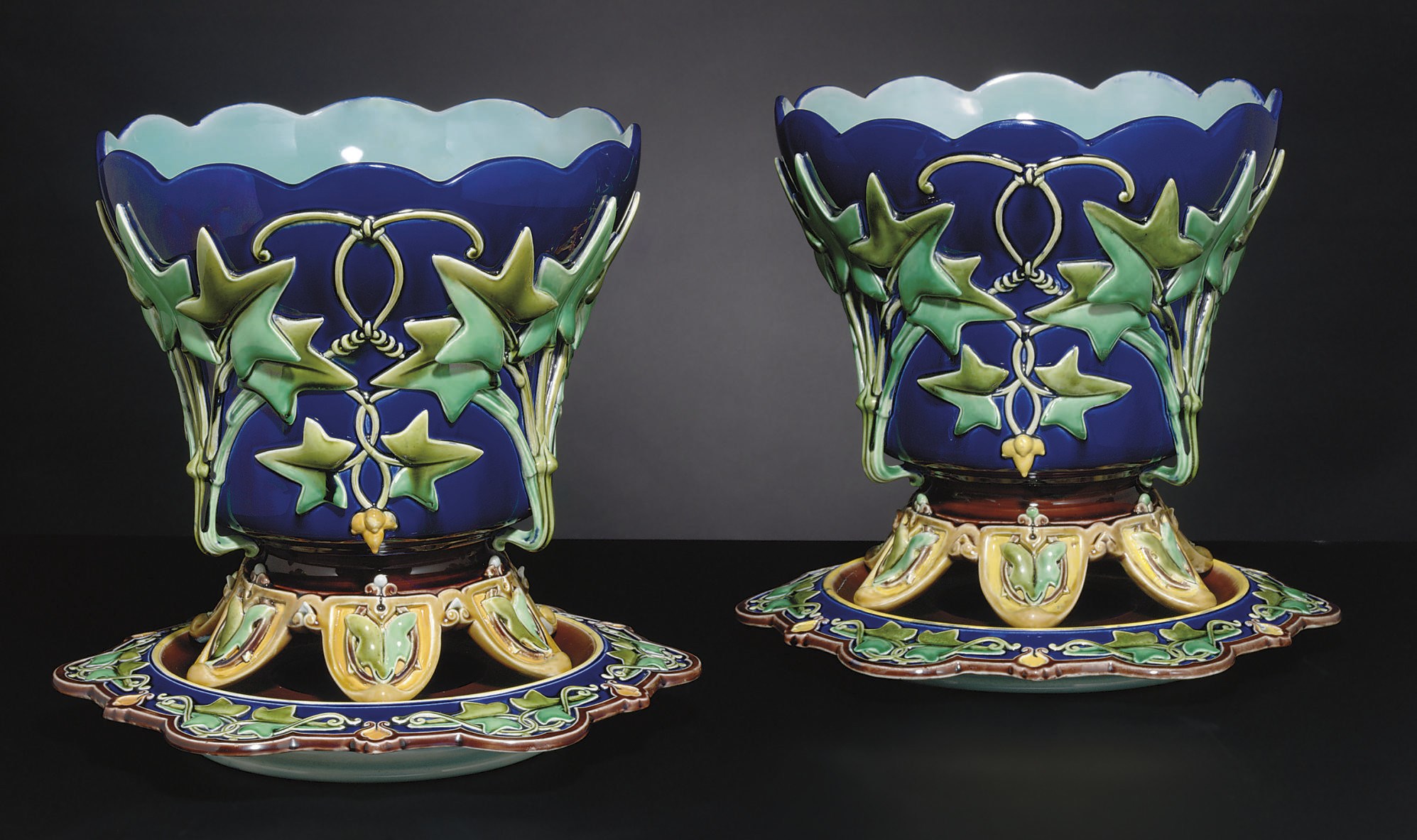 A PAIR OF FRENCH (SARREGUEMINES) MAJOLICA COBALT-BLUE GROUND JARDINIERES AND STANDS