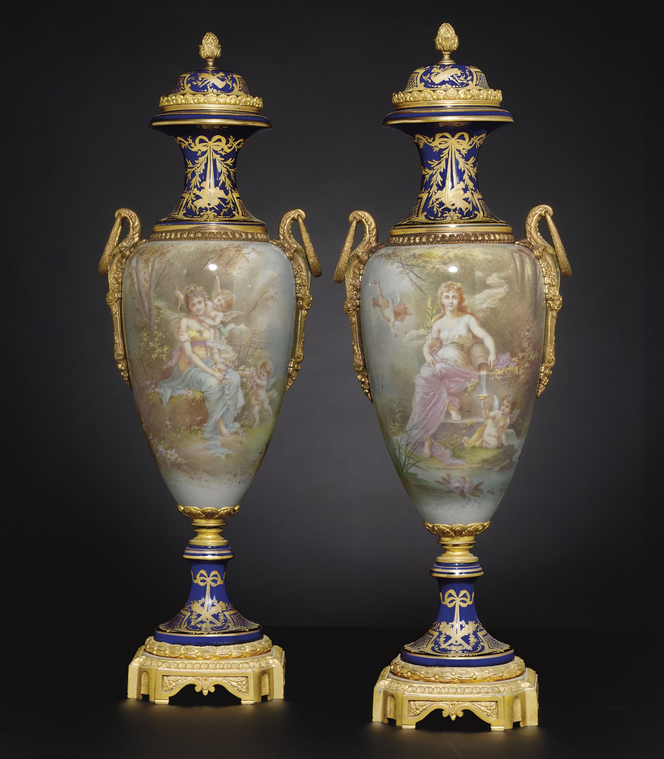 A PAIR OF ORMOLU-MOUNTED SEVRES STYLE COBALT-BLUE GROUND VASES AND COVERS