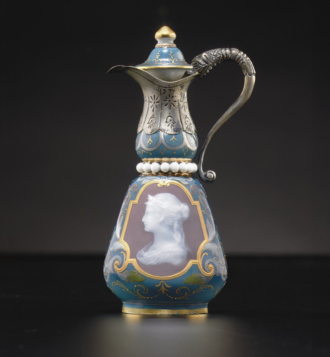 A SILVER-MOUNTED MEISSEN TEAL-GROUND PATE-SUR-PATE SCENT-BOTTLE AND STOPPER ADAPTED AS A EWER