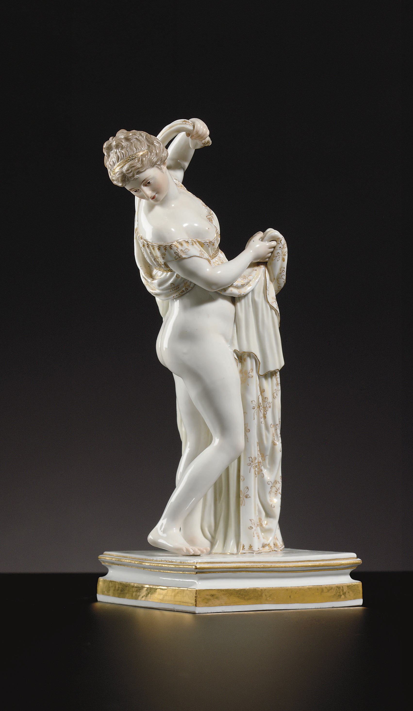 A MEISSEN FIGURE OF A CLASSICAL MAIDEN EN DESHABILLIER