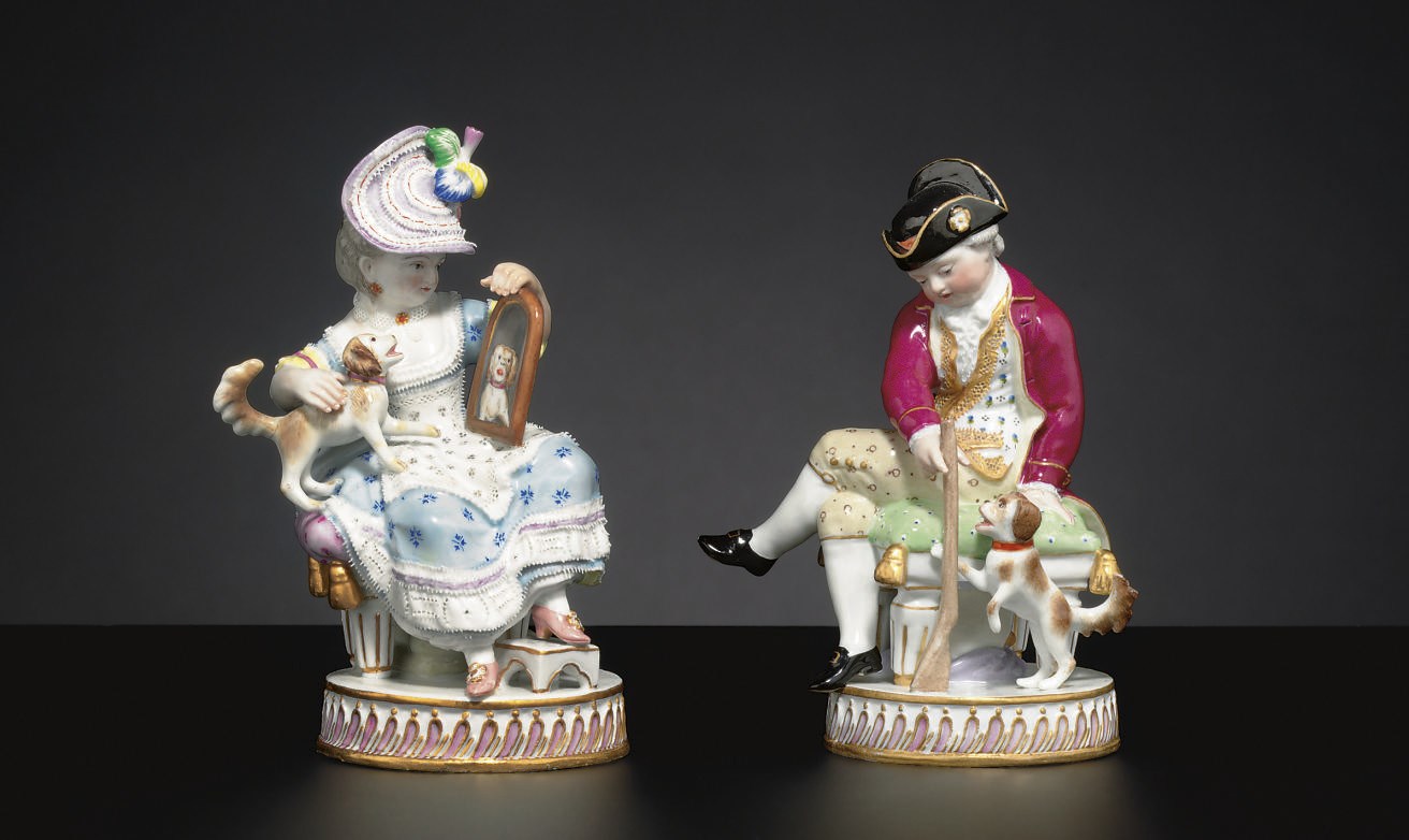 A PAIR OF MEISSEN COMPANION FIGURES WITH DOGS