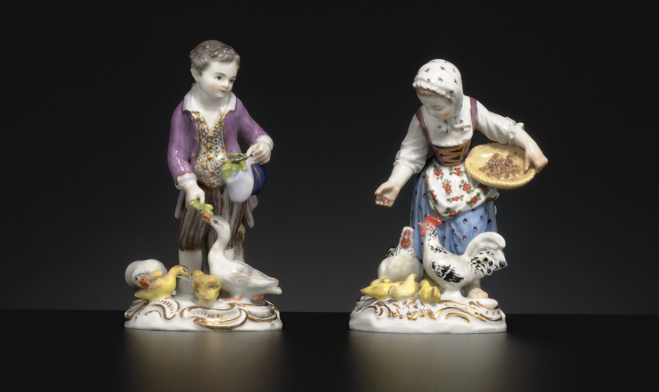 A MATCHED PAIR OF MEISSEN FIGURES OF CHILDREN FEEDING BIRDS