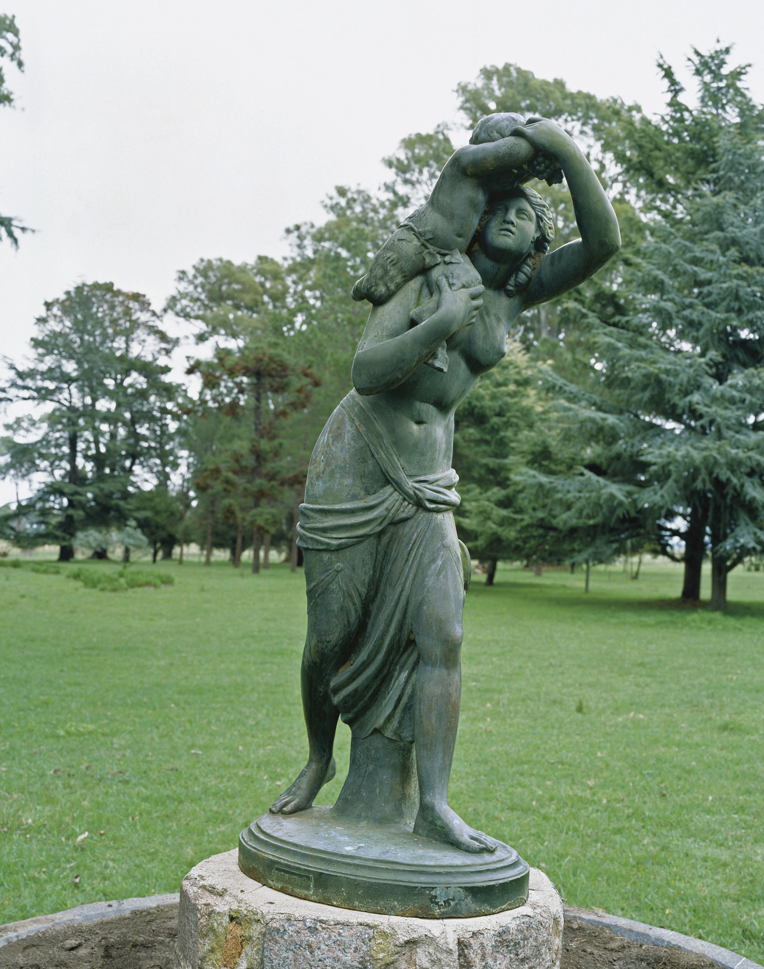 A FRENCH CAST-IRON GROUP OF A BACCHANTE AND FAUN