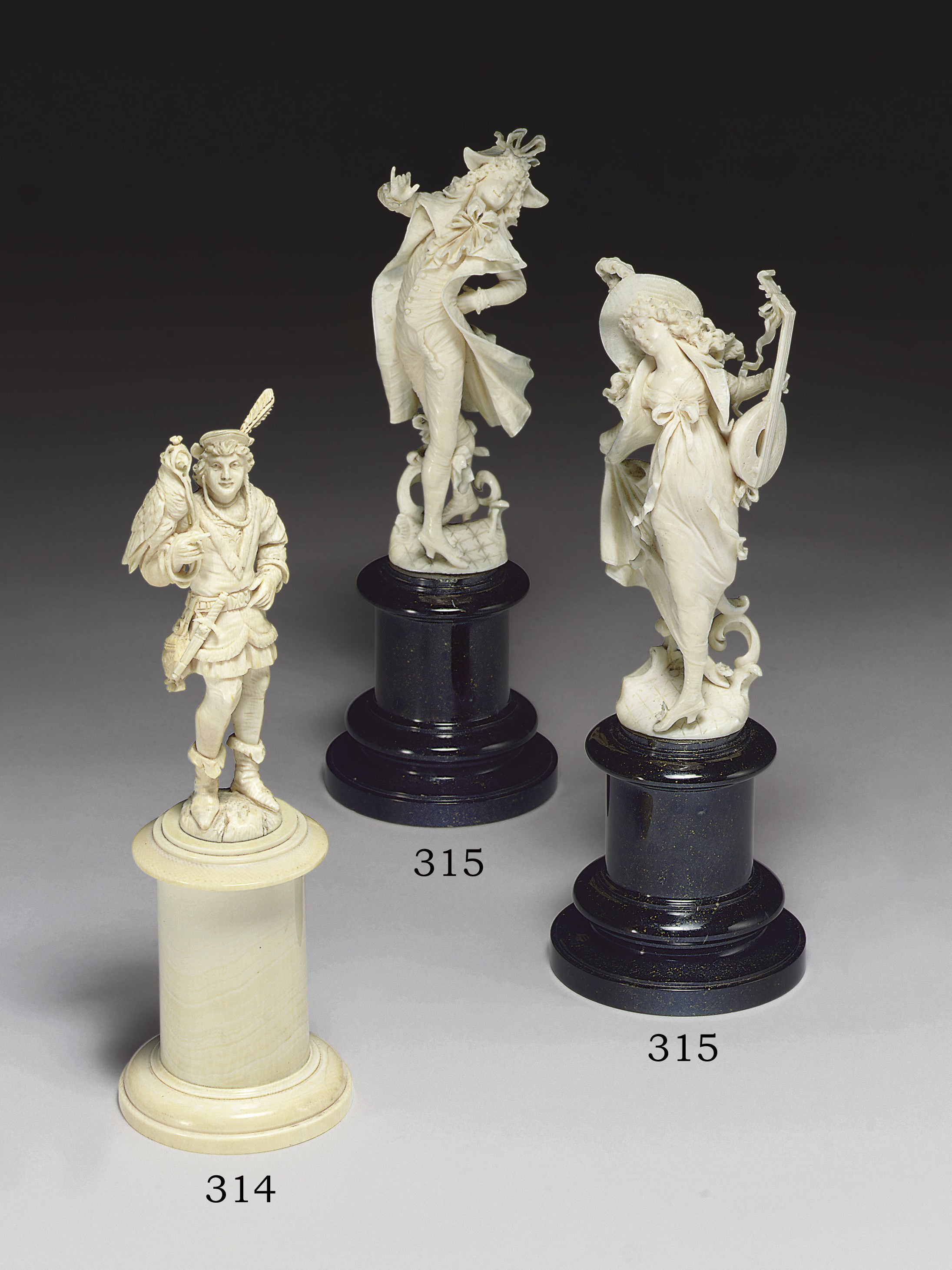 A PAIR OF CONTINENTAL CARVED IVORY FIGURES**