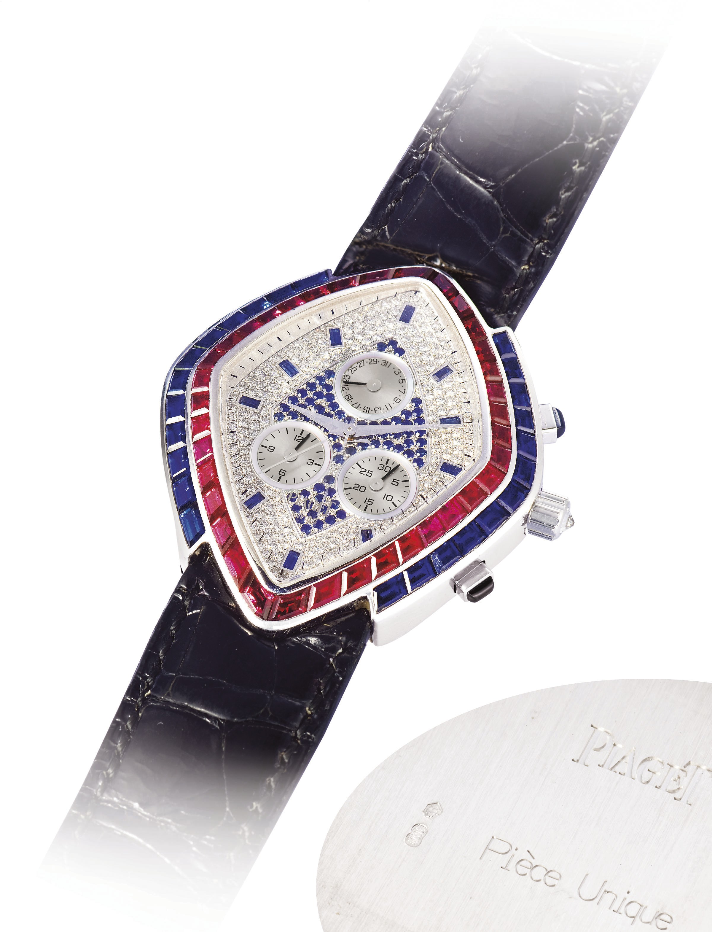 PIAGET, HIGH JEWELLERY PIECE UNIQUE

WHITE GOLD AND DIAMOND-SET QUARTZ CHRONOGRAPH WRISTWATCH WITH DATE DISPLAY, BEZEL SET WITH 60 TRAPEZE AND BAGUETTE-CUT RUBIES AND SAPPHIRES WEIGHING ~6.80 CTS