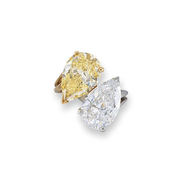 AN IMPORTANT DIAMOND AND COLOURED DIAMOND TWO-STONE CROSSOVER RING, BY ADLER