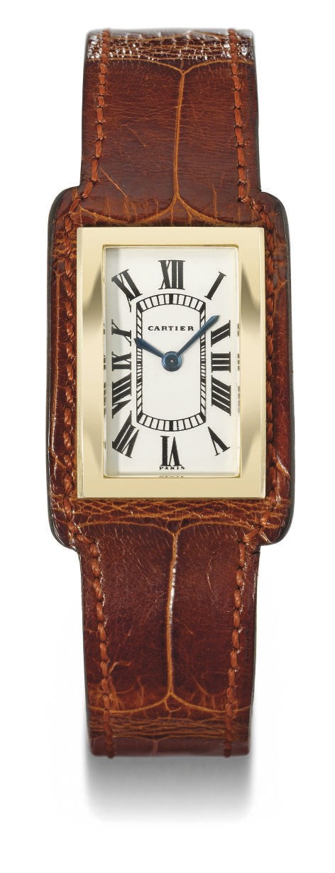 Cartier. An unusual 18K gold rectangular backwound wristwatch set within a leather bracelet