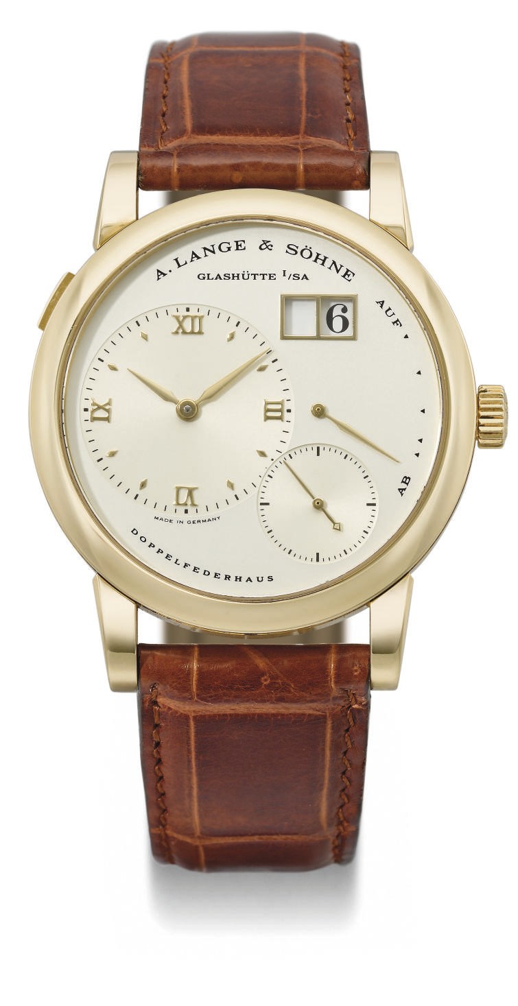 A. Lange & Söhne. A fine 18K gold twin barrel wristwatch with oversized date and power reserve