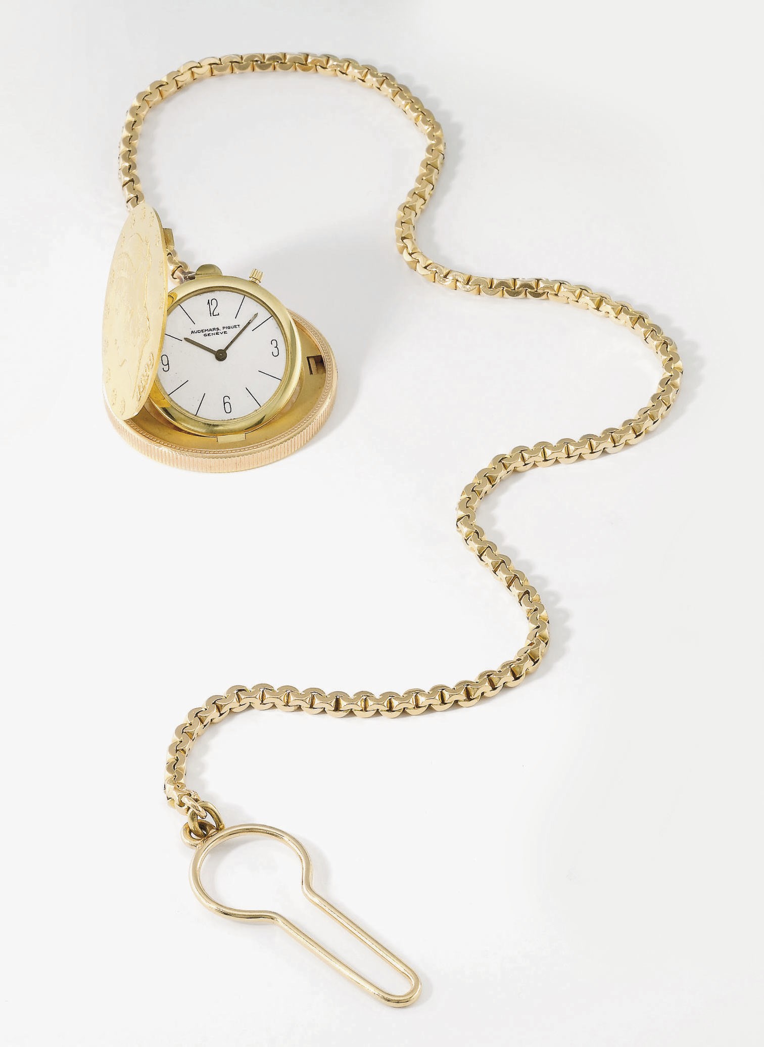 Audemars Piguet. An 18K gold coin watch with chain