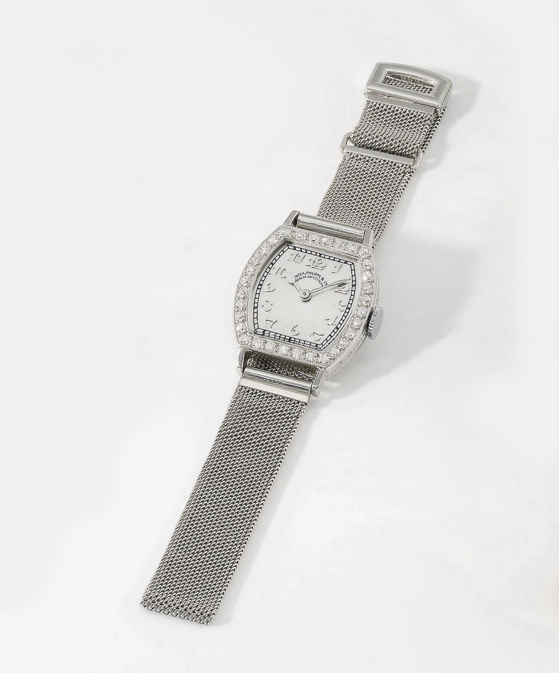 Patek Philippe. A lady's fine, rare and early platinum and diamond-set tonneau-shaped hinged wristwatch with Breguet numerals and bracelet