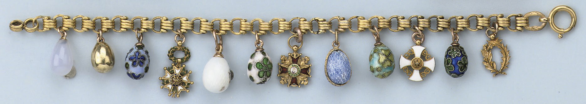 AN ENAMEL EGG CHARM BRACELET