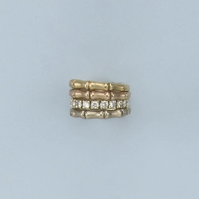 A DIAMOND ETERNITY RING AND THREE GOLD RINGS