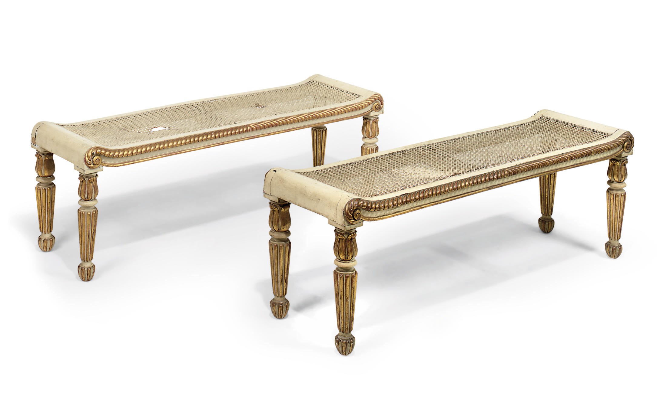 A PAIR OF GEORGE IV PARCEL-GILT AND WHITE PAINTED WINDOW SEATS