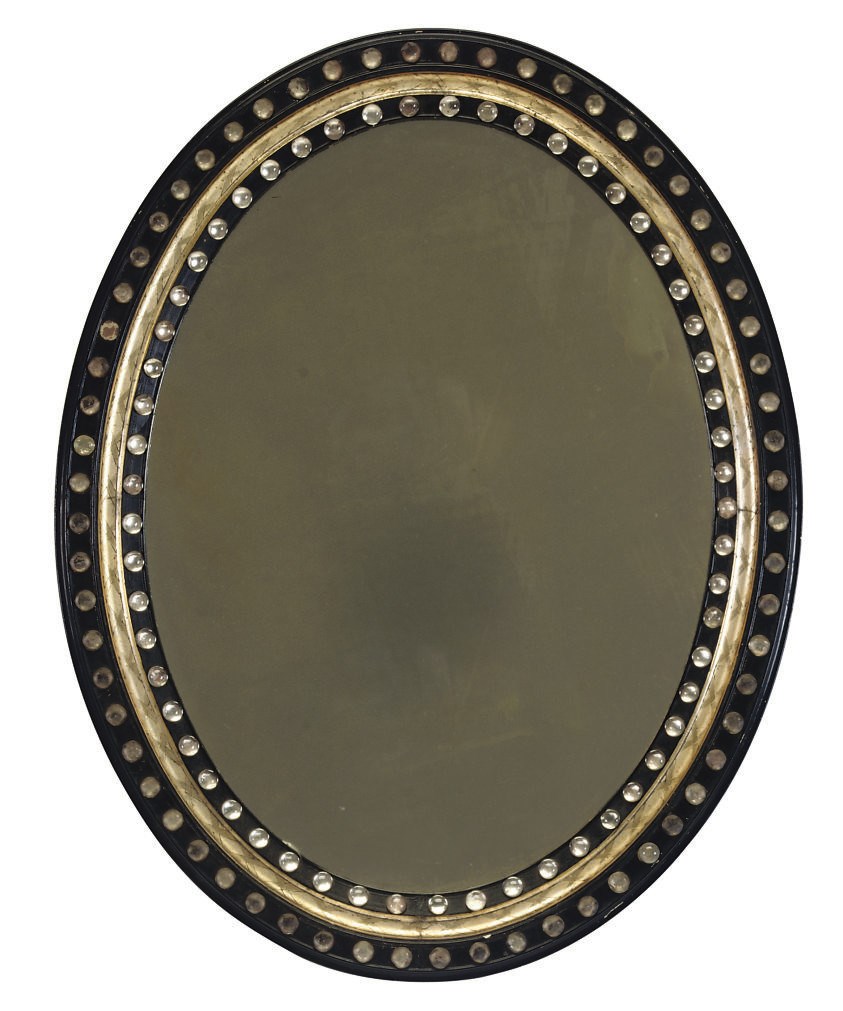 AN IRISH GLASS-MOUNTED EBONISED AND PARCEL-GILT OVAL MIRROR