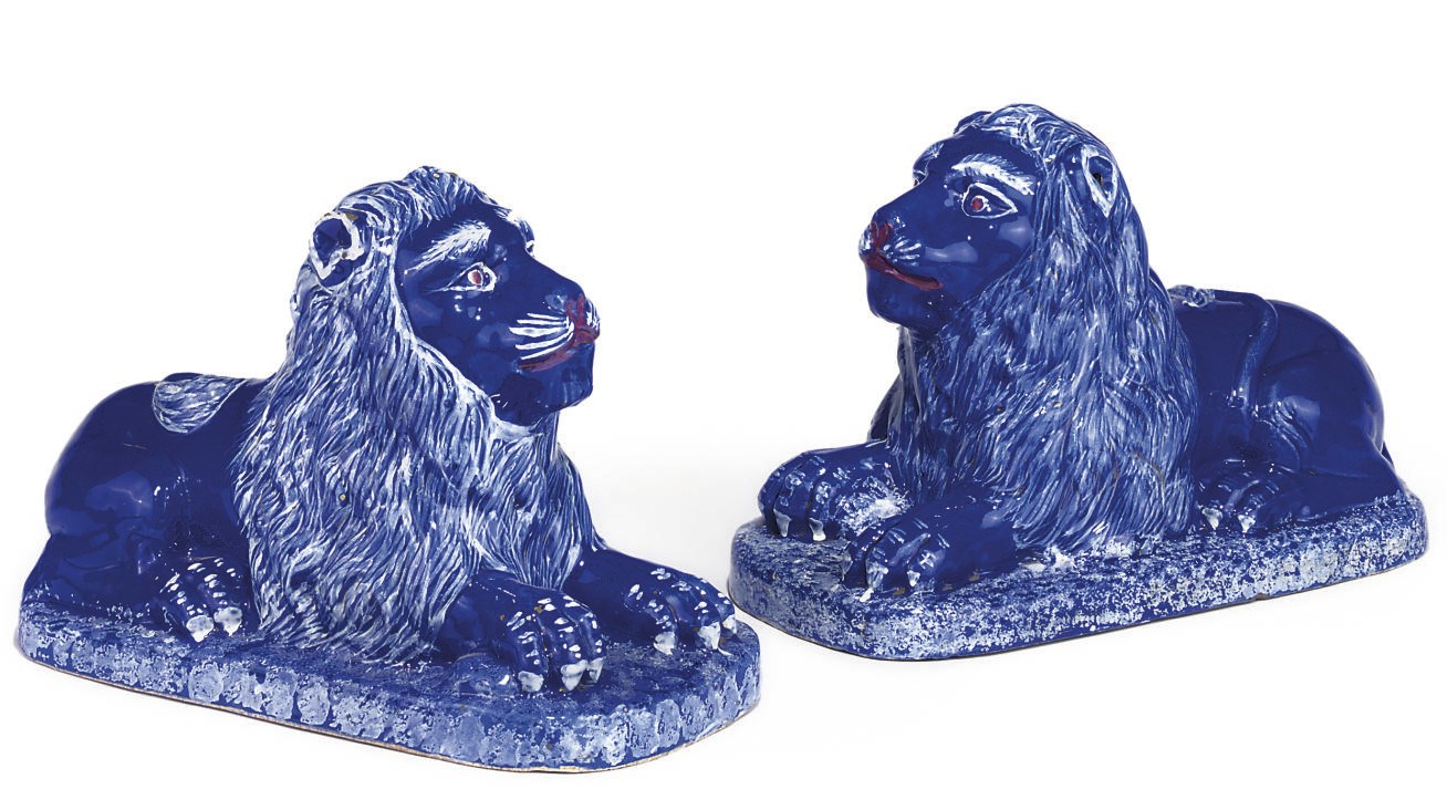 A PAIR OF CONTINENTAL FAIENCE LIONS