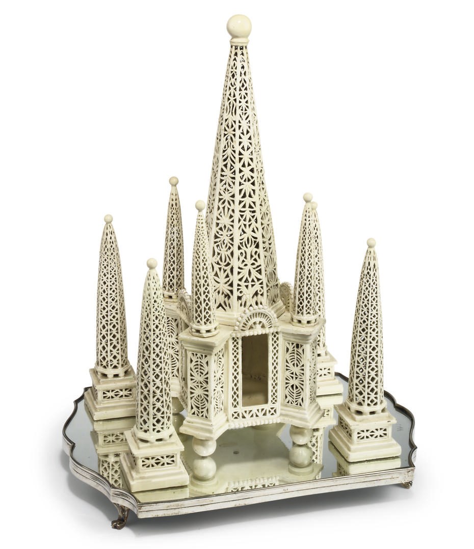 A CONTINENTAL CREAMWARE PIERCED CENTREPIECE ON A MIRROR PLATEAU