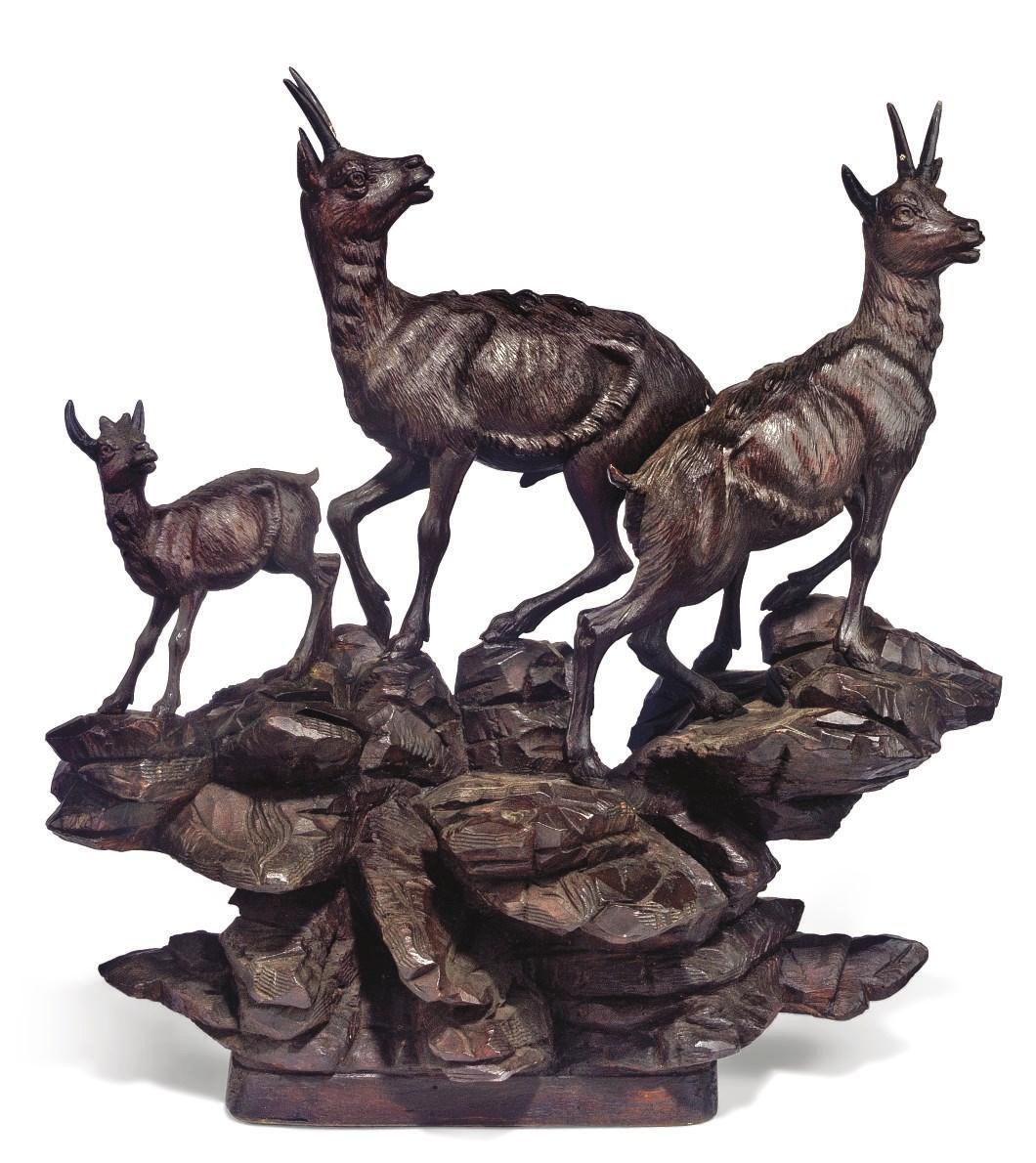 A SWISS 'BLACK FOREST' CARVED AND STAINED WOOD IBEX GROUP