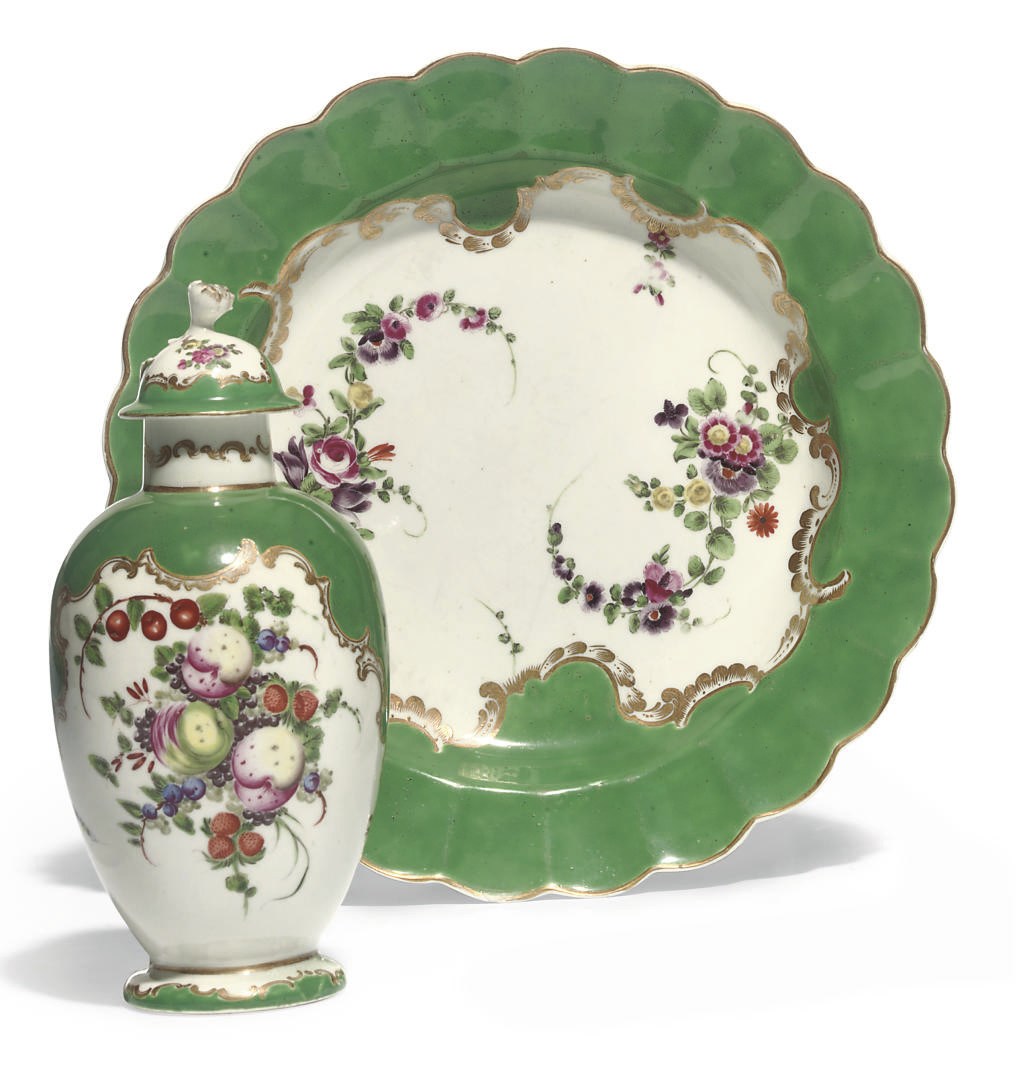 A WORCESTER GREEN-GROUND PLATE AND A LATER-DECORATED TEA-CADDY AND COVER