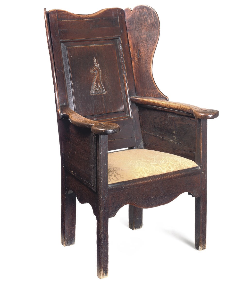 A GEORGE III OAK WING ARMCHAIR