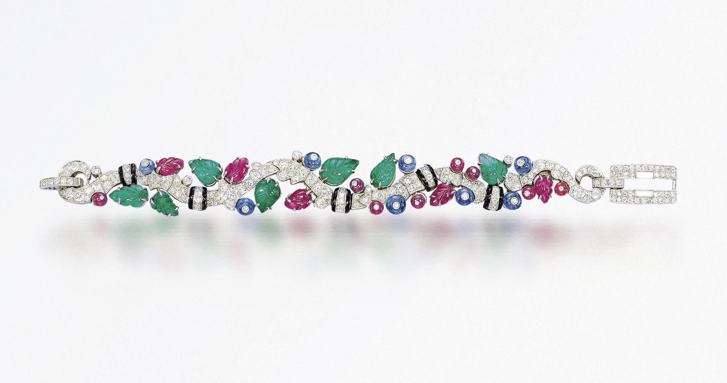 A SUPERB ART DECO SAPPHIRE, EMERALD, RUBY, ENAMEL AND DIAMOND 'TUTTI FRUTTI' BRACELET, BY CARTIER