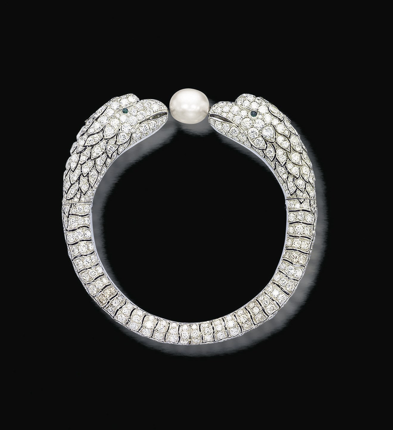 AN EXQUISITE ART DECO NATURAL PEARL, DIAMOND AND EMERALD BANGLE, PROBABLY BY LACLOCHE FRÈRES