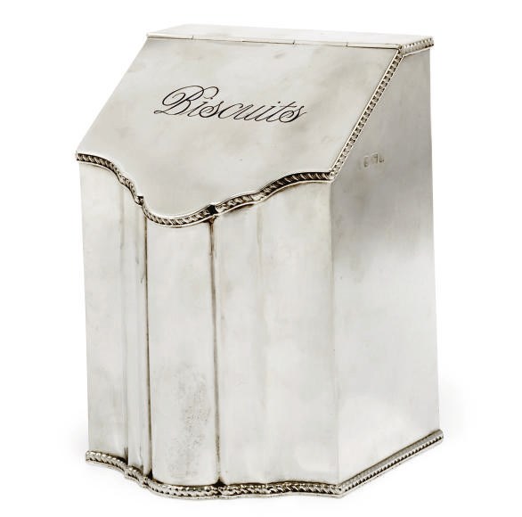 AN EDWARDIAN NOVELTY SILVER BISCUIT BOX IN THE FORM OF A KNIFE BOX