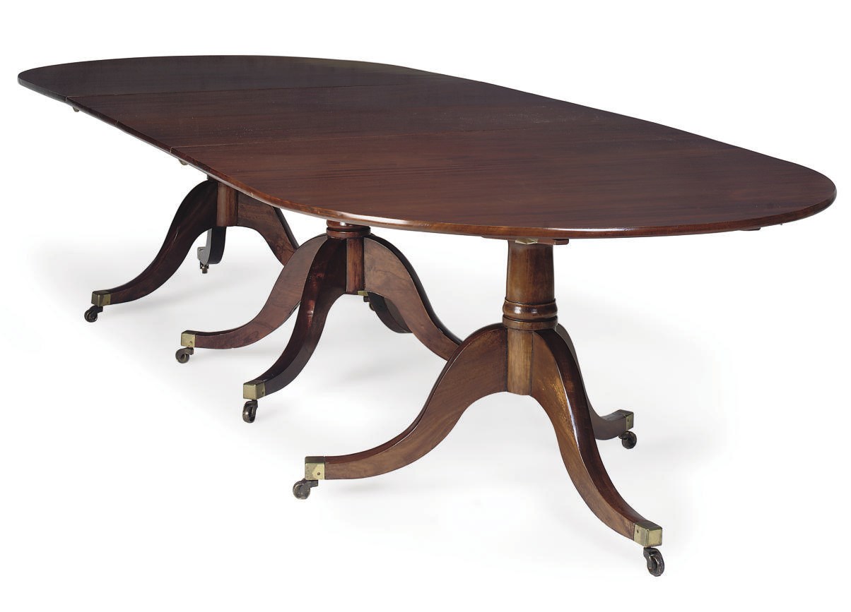 A MAHOGANY TRIPLE PEDESTAL DINING TABLE