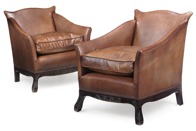 A PAIR OF LEATHER UPHOLSTERED ARMCHAIRS