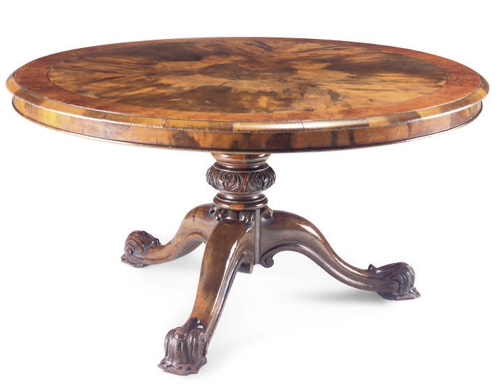 A FIGURED WALNUT CIRCULAR BREAKFAST TABLE