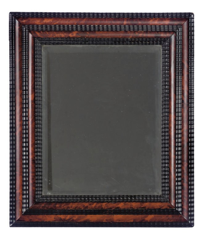 A DUTCH RIPPLE MOULEDED EBONISED AND TORTOISESHELL MIRROR