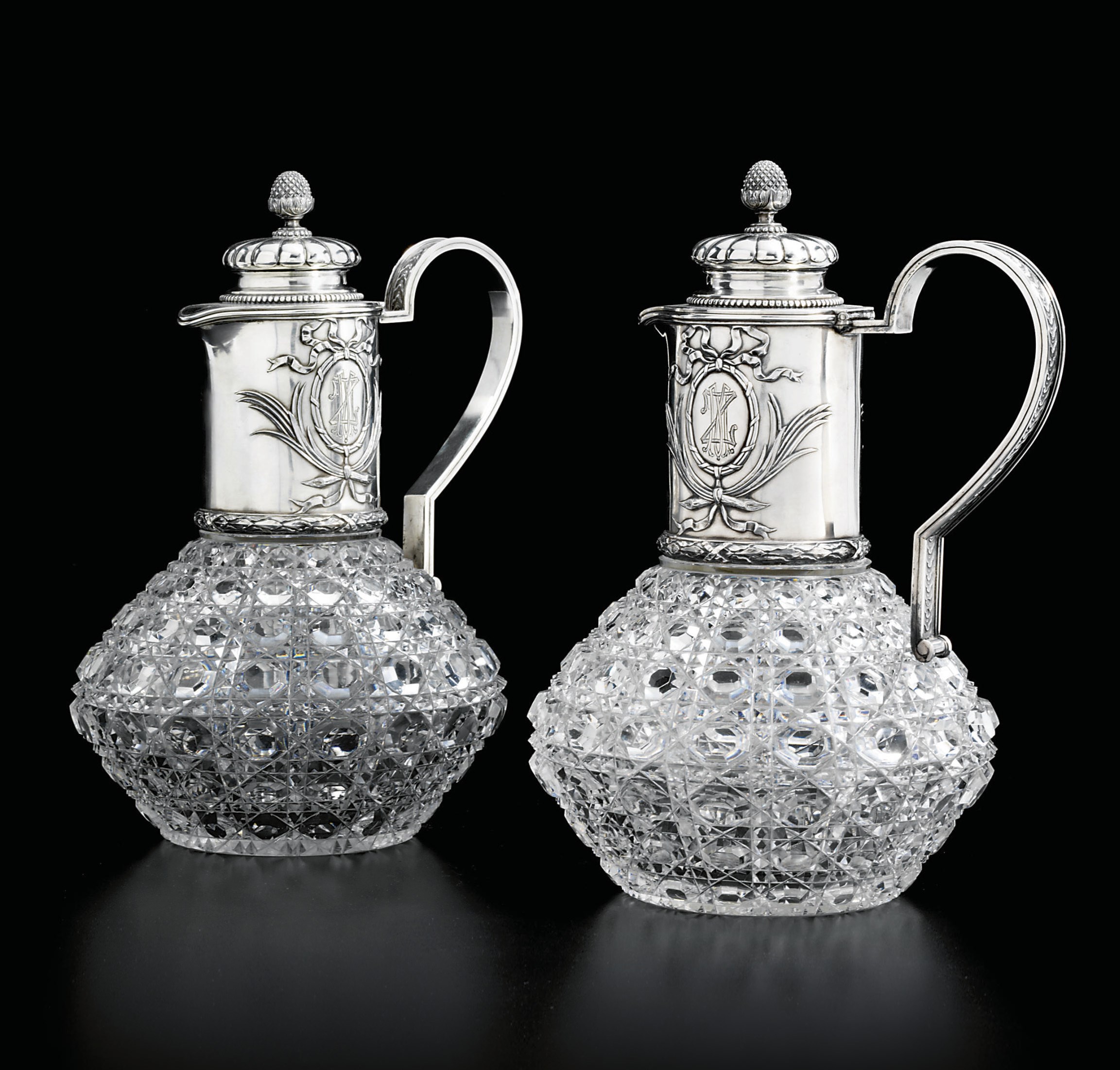 A pair of silver-mounted glass wine jugs