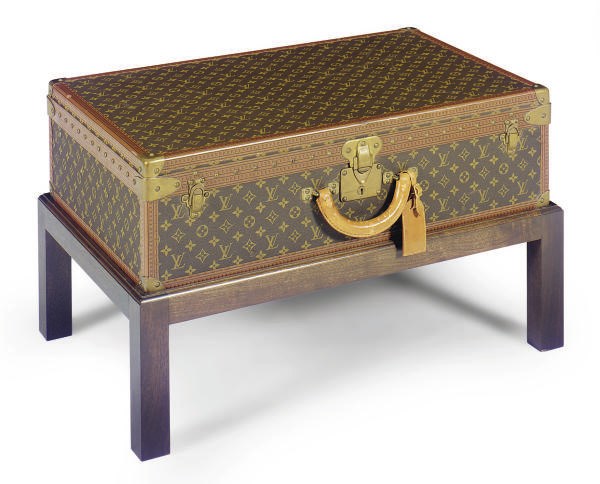 A LOUIS VUITTON SUITCASE ON LATER STAND,