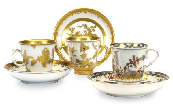 TWO GERMAN PORCELAIN BEAKERS AND SAUCERS AND A SIMILAR AUSTRIAN CUP AND SAUCER,
