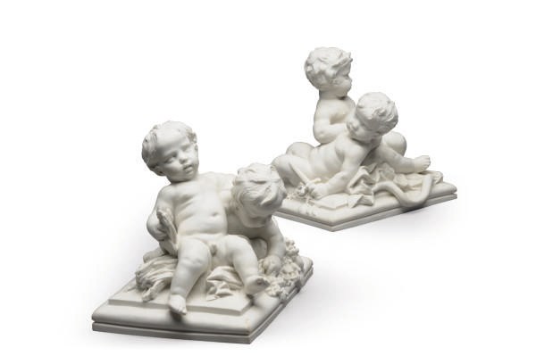 A PAIR OF FRENCH BISCUIT MODELS OF PUTTI,