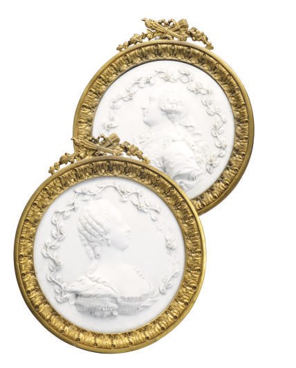 A PAIR OF CONTINENTAL BISCUIT PORCELAIN PLAQUES IN GILT METAL FRAMES DEPICTING MARIE ANTOINETTE AND LOUIS XVI,