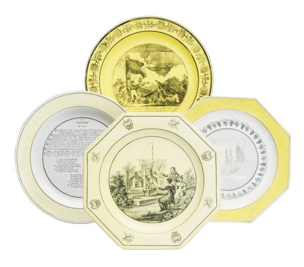 A GROUP OF NINETEEN FRENCH YELLOW-GROUND BLACK-PRINTED CREAMWARE PLATES AND A PUNCH BOWL,